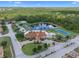 Aerial view of community center featuring a pool, tennis courts, playground, and surrounding green spaces at 1434 Pacific Rd, Kissimmee, FL 34759