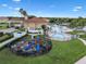 Aerial view of community center with pool, playground, and well-manicured landscaping showcasing the amenities at 1434 Pacific Rd, Kissimmee, FL 34759