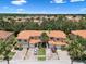 Aerial view of condos featuring brick driveways and lush tropical landscaping at 1434 Pacific Rd, Kissimmee, FL 34759