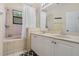 Well-lit bathroom features a dual vanity, and shower-tub combination at 1434 Pacific Rd, Kissimmee, FL 34759