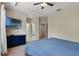 View of bedroom with carpeted floors, ceiling fan, and open door to a carpeted hallway at 1434 Pacific Rd, Kissimmee, FL 34759