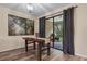 Cozy dining area features wood-look floors, sliding glass doors to the patio, and rustic wood table at 1434 Pacific Rd, Kissimmee, FL 34759