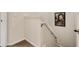 Stairwell with carpeted steps and a white banister on a white wall at 1434 Pacific Rd, Kissimmee, FL 34759