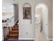 Hallway featuring arched doorways, staircase, and bathroom, connecting various parts of the home at 1434 Pacific Rd, Kissimmee, FL 34759