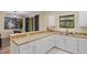 Bright kitchen view showcasing lots of counter space, stainless steel appliances, and a breakfast bar at 1434 Pacific Rd, Kissimmee, FL 34759