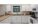 This kitchen features stainless steel appliances, and a window view of a private garden at 1434 Pacific Rd, Kissimmee, FL 34759