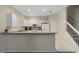 The well-lit kitchen includes white cabinets, stainless steel appliances, and a breakfast bar at 1434 Pacific Rd, Kissimmee, FL 34759
