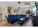 Inviting living room featuring a blue sectional sofa, staircase, and stylish wood-look flooring at 1434 Pacific Rd, Kissimmee, FL 34759