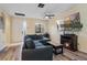 Bright living room features a comfortable sectional, an electric fireplace, and wood-look floors at 1434 Pacific Rd, Kissimmee, FL 34759