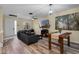 A cozy living room showcasing a comfortable couch, wood-look flooring, and a modern entertainment setup at 1434 Pacific Rd, Kissimmee, FL 34759