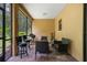 Enclosed patio with brick flooring, featuring a grill and comfortable seating perfect for gatherings at 1434 Pacific Rd, Kissimmee, FL 34759