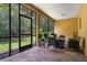 Inviting screened-in patio with brick flooring and comfortable seating, perfect for outdoor dining at 1434 Pacific Rd, Kissimmee, FL 34759