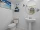 Neat powder room with white walls, vanity sink, and tropical decorations at 1434 Pacific Rd, Kissimmee, FL 34759