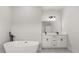 Stylish bathroom with a modern standalone tub and a double vanity with sleek fixtures at 14905 Sw 39Th Cir, Ocala, FL 34473