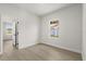 Bright bedroom features wood-look floors, a window, and white walls at 14905 Sw 39Th Cir, Ocala, FL 34473