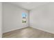 This bedroom features neutral wood-look floors and large windows at 14905 Sw 39Th Cir, Ocala, FL 34473