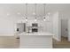 Modern kitchen featuring stainless steel appliances, island with pendant lighting, and ample storage at 14905 Sw 39Th Cir, Ocala, FL 34473