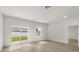 Bright living room with sliding glass doors, wood-look flooring and neutral decor at 14905 Sw 39Th Cir, Ocala, FL 34473