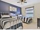 Stylish bedroom featuring two twin beds, modern decor, and a calming color scheme at 1606 Lima Ave, Kissimmee, FL 34747