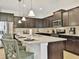 Spacious kitchen featuring a large island with seating, granite countertops, and stainless steel appliances at 1606 Lima Ave, Kissimmee, FL 34747