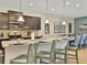 Open-concept kitchen with granite countertops, a breakfast bar, and views of the dining area at 1606 Lima Ave, Kissimmee, FL 34747