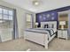 Serene main bedroom with a king-sized bed, ambient lighting, and elegant wall decor at 1606 Lima Ave, Kissimmee, FL 34747