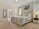 Comfortable main bedroom with a king bed, decorated wall, and a ceiling fan at 1606 Lima Ave, Kissimmee, FL 34747
