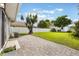 A view of the big backyard showing a brick patio, lawn, new white fence and storage shed at 1615 W Gadsen Blvd, Orlando, FL 32812