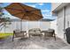 Stylish patio seating provides a great view of the fenced backyard for relaxing and entertainment at 1615 W Gadsen Blvd, Orlando, FL 32812