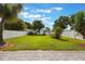 Large fenced backyard with a vibrant lawn, beautiful trees, and privacy for outdoor enjoyment and relaxation at 1615 W Gadsen Blvd, Orlando, FL 32812