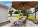 Brick patio in a fenced backyard with lush green lawn and a view of the storage shed at 1615 W Gadsen Blvd, Orlando, FL 32812
