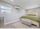 Serene bedroom with a neutral color palette, a plush rug, and a modern air conditioning unit at 1615 W Gadsen Blvd, Orlando, FL 32812
