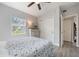 Cozy bedroom with a ceiling fan, a light-colored dresser, and wood-look flooring at 1615 W Gadsen Blvd, Orlando, FL 32812