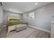 Well-lit bedroom with a cozy rug, neutral color scheme, and a bench at the foot of the bed at 1615 W Gadsen Blvd, Orlando, FL 32812
