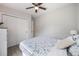 Comfortable bedroom with a ceiling fan, a light-colored dresser, and closet doors at 1615 W Gadsen Blvd, Orlando, FL 32812