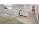 Comfortable bedroom featuring wood-look floors, a white dresser, and an ensuite bathroom at 1615 W Gadsen Blvd, Orlando, FL 32812