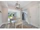 Dining room with a wooden bench, light fixtures, and open access to the kitchen and living room at 1615 W Gadsen Blvd, Orlando, FL 32812