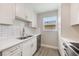 Modern kitchen with stainless steel appliances, quartz countertops, and subway tile backsplash at 1615 W Gadsen Blvd, Orlando, FL 32812