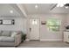Bright living room featuring a white front door and luxury vinyl plank flooring at 1615 W Gadsen Blvd, Orlando, FL 32812