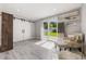 Cozy living area boasts a sliding glass door to backyard and a decorative barn door at 1615 W Gadsen Blvd, Orlando, FL 32812
