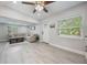 Spacious living room featuring luxury vinyl plank flooring, windows and a cozy couch at 1615 W Gadsen Blvd, Orlando, FL 32812