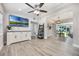 Bright living room features light wood floors, updated fixtures, and flows into the dining area at 1615 W Gadsen Blvd, Orlando, FL 32812