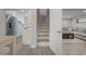 Open-concept living space with modern finishes, including an eat-in kitchen, stairs, and a comfortable living area at 1615 W Gadsen Blvd, Orlando, FL 32812