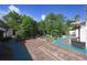 Expansive backyard features a brick patio surrounded by lush greenery, creating a serene outdoor living space at 1621 Sunnyside Dr, Maitland, FL 32751
