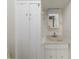 Bathroom featuring a stylish vanity with elegant fixtures and a matching mirror above at 1621 Sunnyside Dr, Maitland, FL 32751