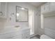 Bright bathroom with a large mirror, vanity, and a walk-in shower at 1621 Sunnyside Dr, Maitland, FL 32751