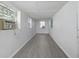 A white bedroom with plank floors, three windows, and an air conditioner at 1621 Sunnyside Dr, Maitland, FL 32751