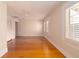 Bright bedroom features gleaming wood floors and ample natural light through shuttered windows at 1621 Sunnyside Dr, Maitland, FL 32751
