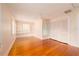Bright bedroom features gleaming wood floors, built-in shelves, closet, and ample natural light at 1621 Sunnyside Dr, Maitland, FL 32751
