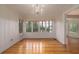 Dining room with hardwood floors, natural light, and elegant chandelier at 1621 Sunnyside Dr, Maitland, FL 32751